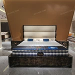 Soft Upholstered Bed with Embossed Brand Mark, Rich-Patterned Natural Wood Veneer Trim & Polished Gold Stainless Steel Accents